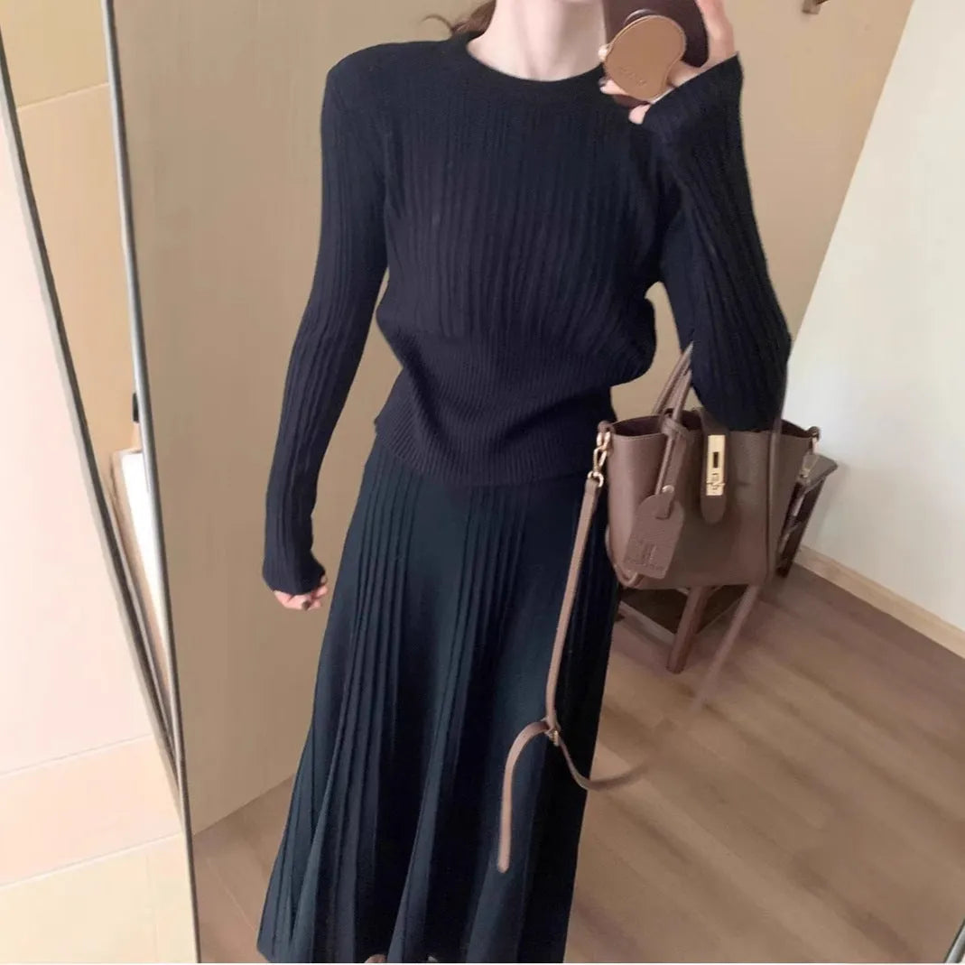 Dark grey knitted sweater and skirt set with a raised 3D pattern, shown as a complete artistic retro outfit.