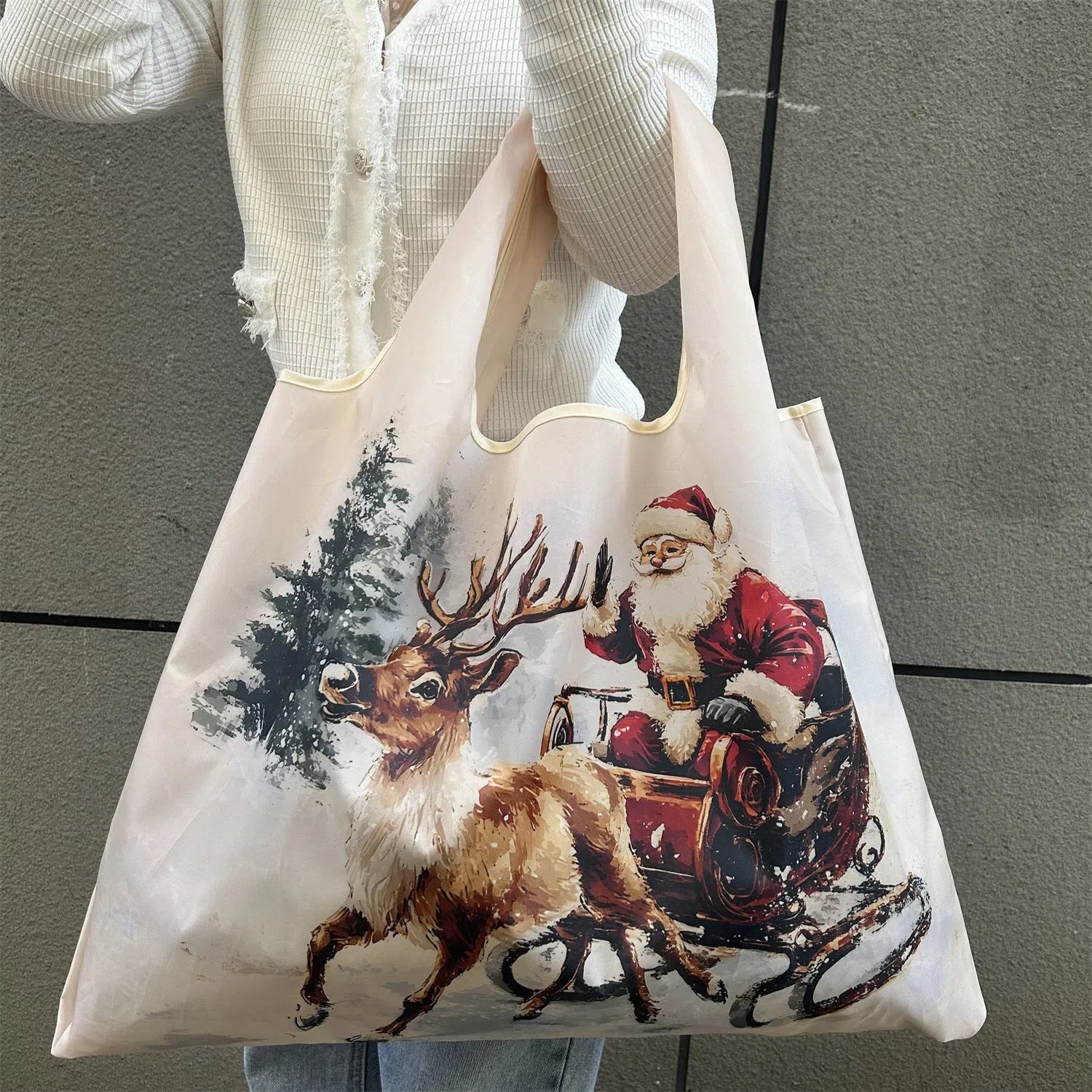 Large one-shoulder polyester Santa Claus gift bag with festive red and white design