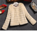 Women's short-length faux fur top in beige, shown on a model.
