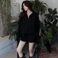 Creamy-white women's knitted jumper and shorts set with geometric pattern and elastic waistband.