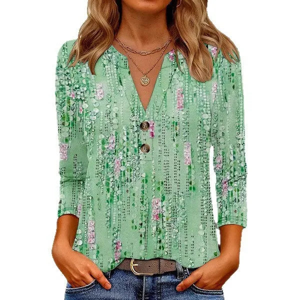 Women's loose grey V-neck t-shirt with a colourful 3D geometric pattern on the front.