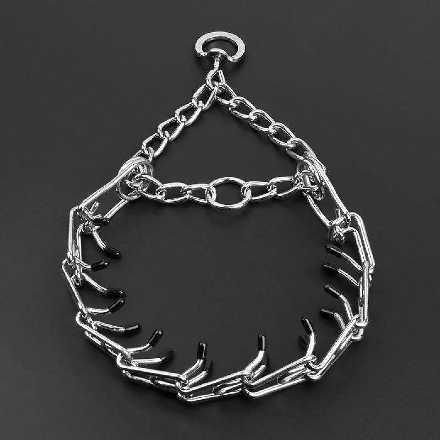 Stainless steel dog prong training collar with comfort rubber tips and adjustable chain links on a grey background.