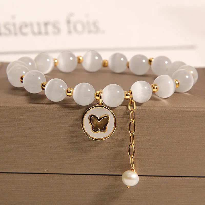 Handmade white cat's eye crystal bracelet with geometric Korean-style design.
