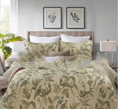 Blue American floral and bird pattern quilted cotton bedspread set on a bed