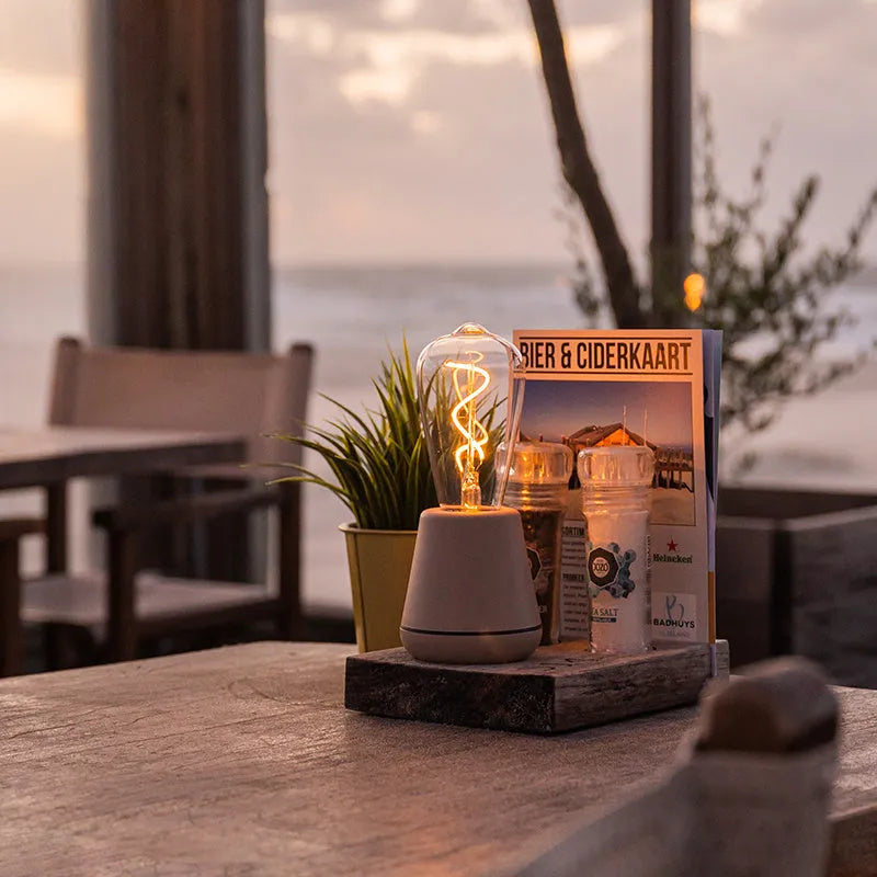 Portable LED camping lantern with aluminium body and 3-speed adjustable brightness in outdoor setting