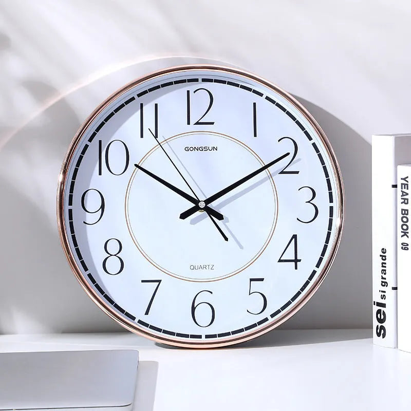 14-inch round wall clock with white face, black numbers, and sweep second movement on a light wall