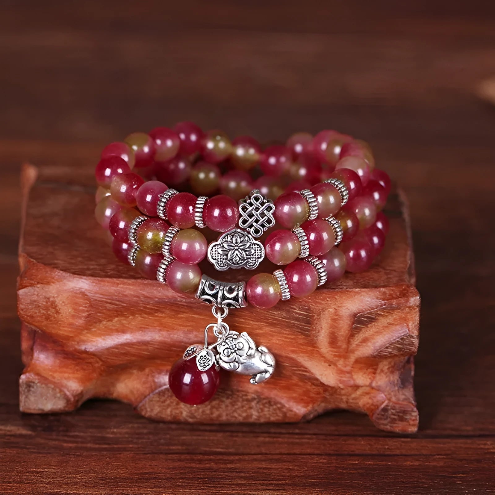 Handcrafted watermelon crystal bracelet with Chinese knot design showing 8mm elephant-style beads
