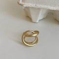Geometric open ring with interlaced matte metal construction in gold and silver plating options