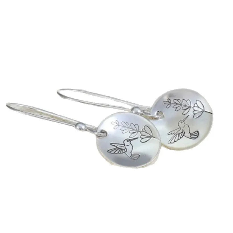 Silver round women's earrings with engraved bird and floral designs in glossy finish
