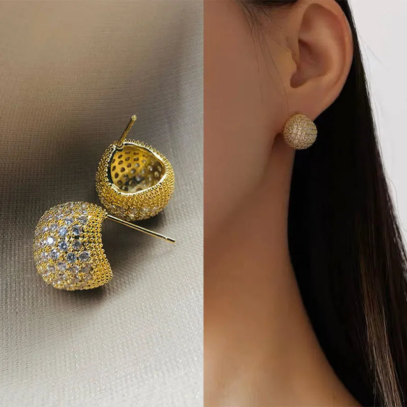 Geometric drop-shaped earrings with full diamond detailing, spherical elements, and little golden beans motif in gold or white colour