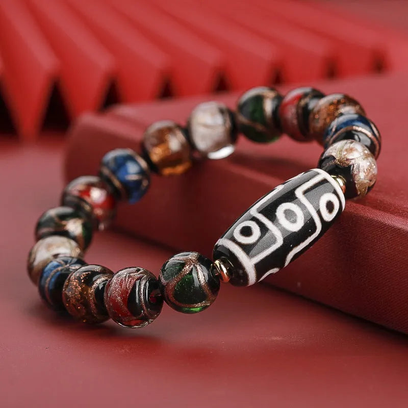 Close-up of a handcrafted coloured glaze bracelet with multi-colour lucky beads and auspicious Chinese patterns.