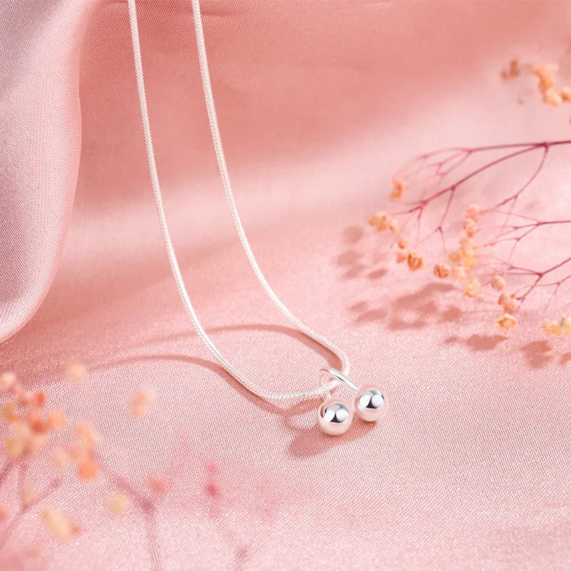 Silver cherry pendant necklace for women with adjustable snake chain.