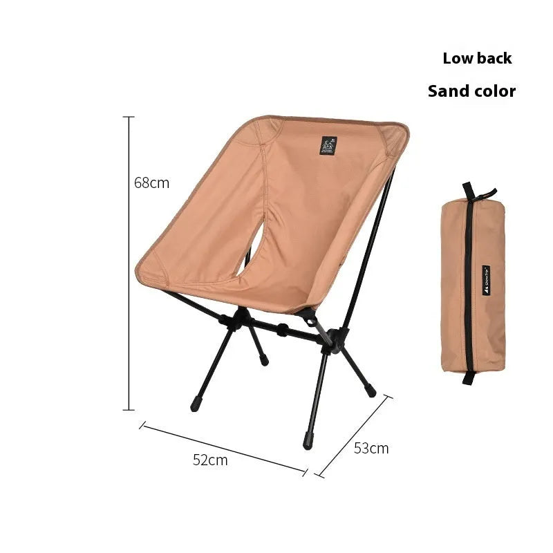 Lightweight aluminium folding moon chair in a garden setting, shown in sand colour with a high back.