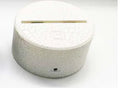 White lotus-shaped acrylic night light with LED base and touch controls on a wooden table.