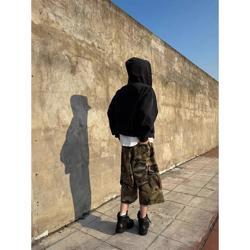 Men's camouflage cropped jeans with ripped detailing and retro patches in loose straight cut