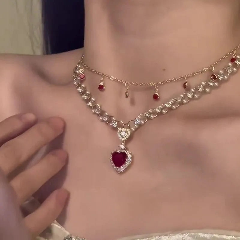 Red love heart pendant on a double layer alloy necklace with an adjustable chain.