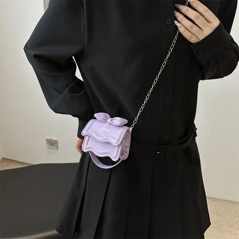 Mini crossbody bag in seven colour options with single shoulder strap and structured PU construction