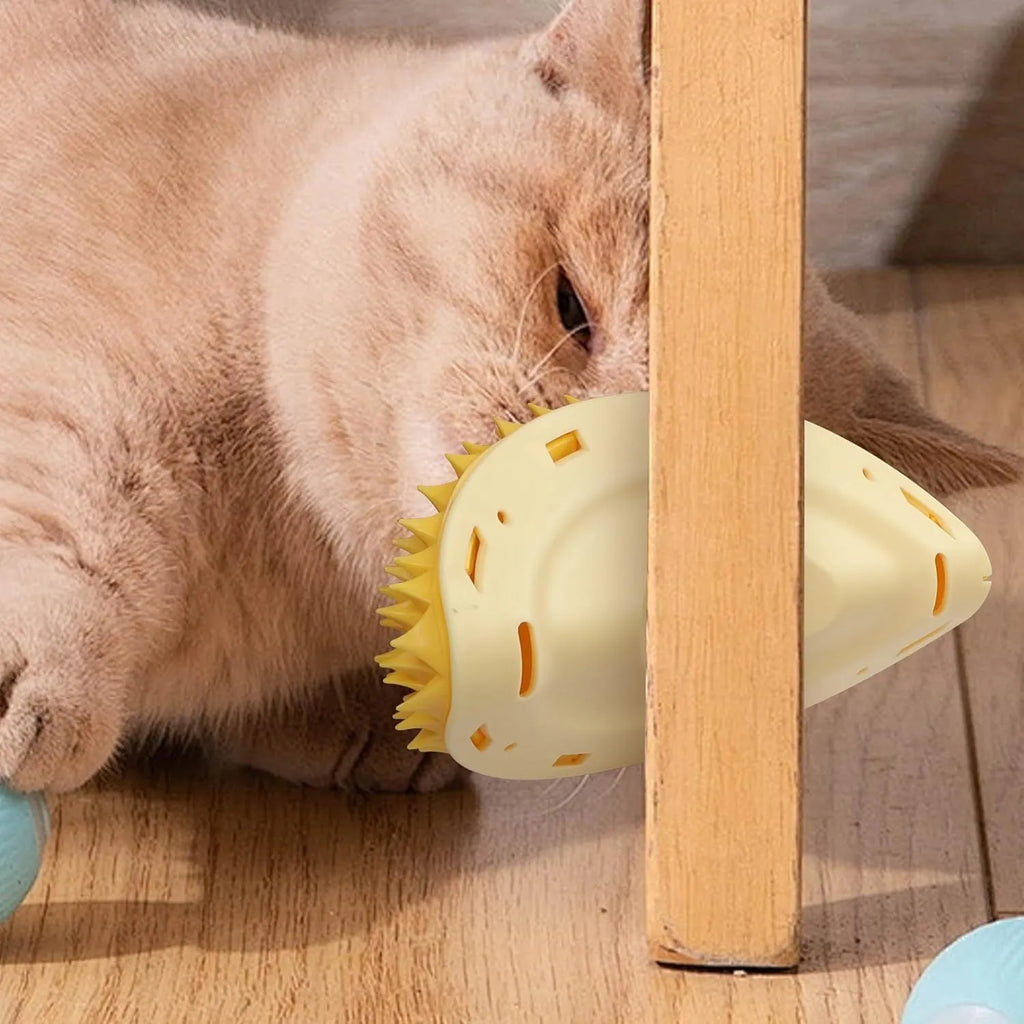Yellow durian-shaped cat corner scratcher with grooming comb attached to a wall.