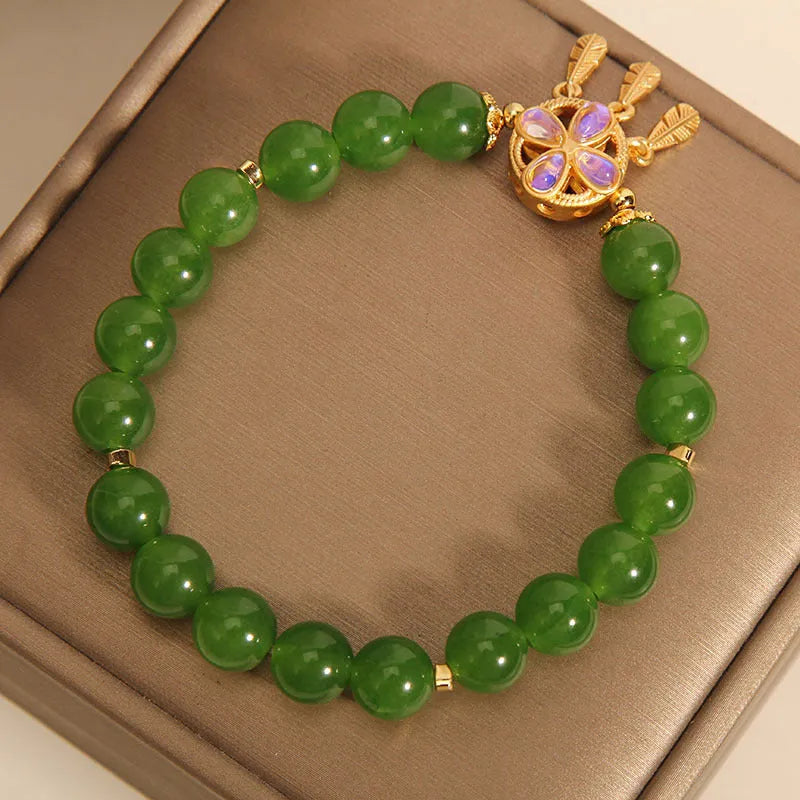Green jasper crystal four-leaf clover dream catcher pendant on an adjustable women's bracelet.