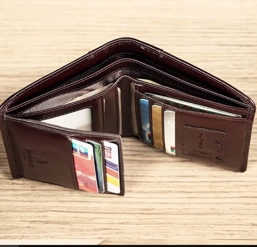 Men's black full-grain leather bifold wallet open, showing card slots, note pocket, and zipped coin compartment.