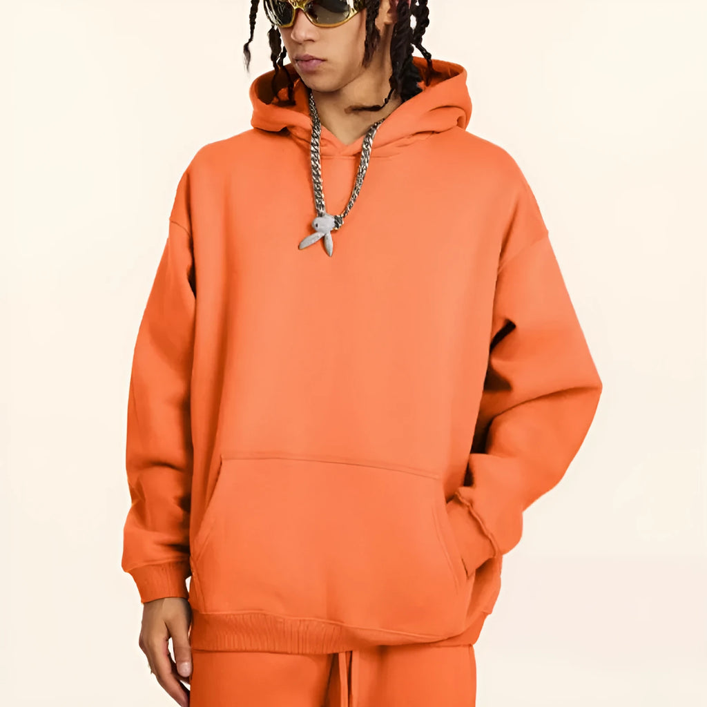 A loose grey men's cotton hooded sweater with drop-shoulder sleeves on a hanger.
