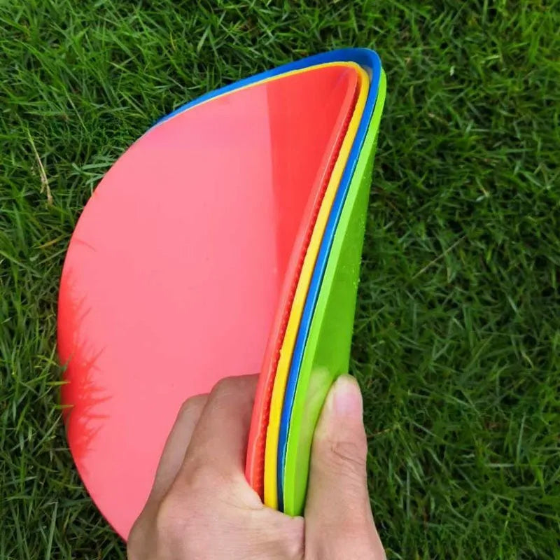 Circular yellow football training marker disc on grass field showing 23cm diameter