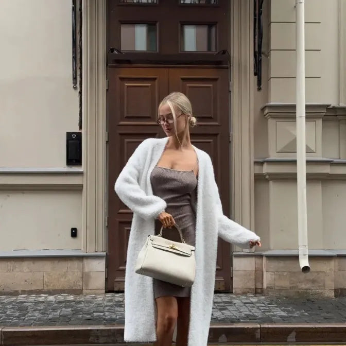 White longline knitted cardigan jacket for women, shown loose-fit with long sleeves.