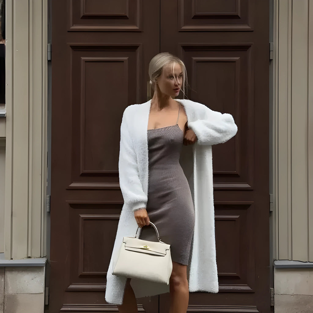 White longline knitted cardigan jacket for women, shown loose-fit with long sleeves.