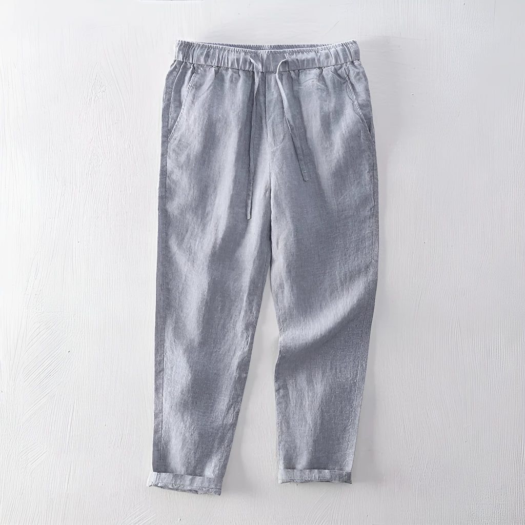 Men's straight-leg linen trousers in light grey colour showing mid-waist and straight-leg cut
