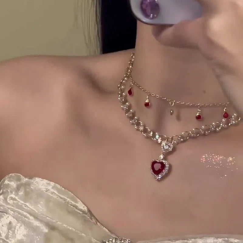 Red love heart pendant on a double layer alloy necklace with an adjustable chain.