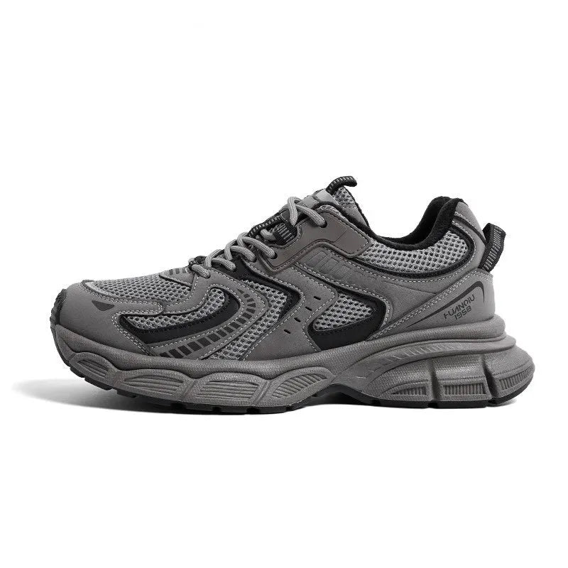 Grey chunky platform sneakers with leather stitching and lace-up design on a white background.