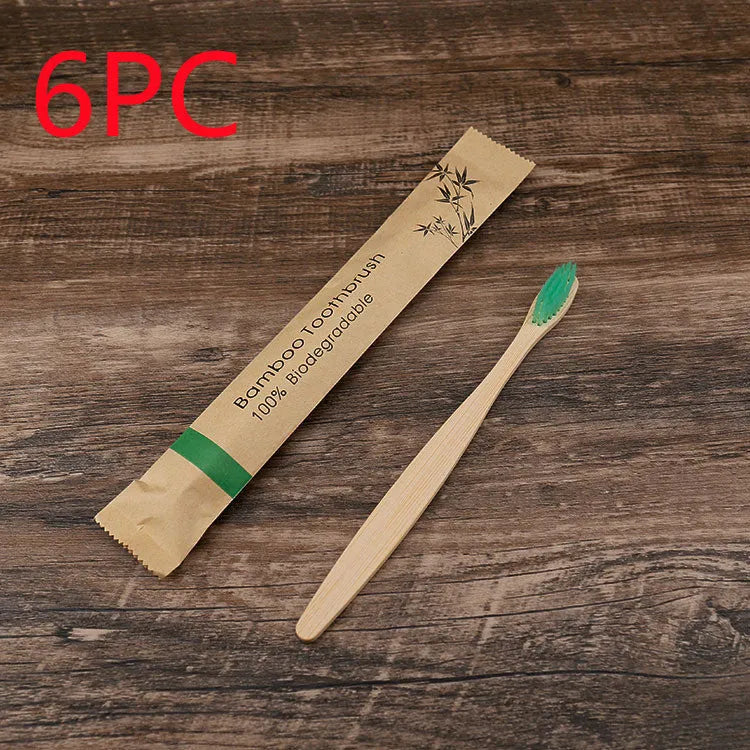 10 multi-coloured natural bamboo toothbrushes with soft charcoal bristles arranged on a white background
