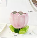 Ceramic pen holder storage box with floral pattern decoration on desktop