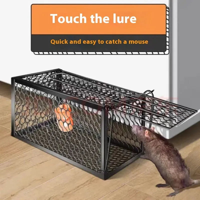 A galvanised metal humane live-catch mouse trap with a single door, shown on a wooden surface.