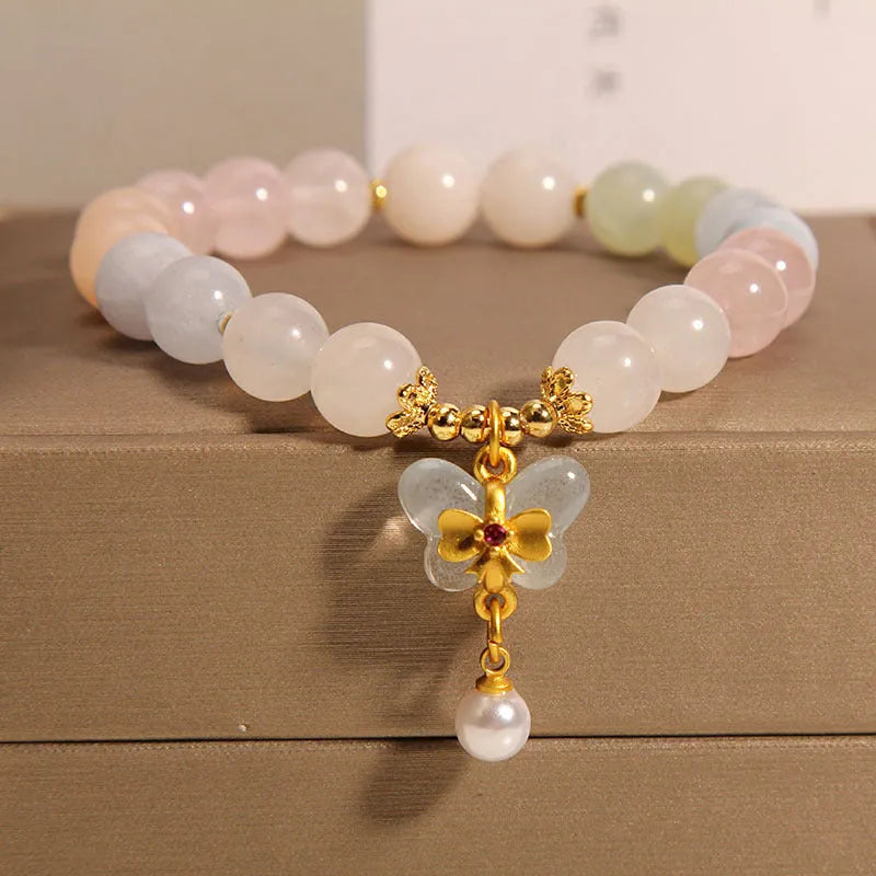 Women's crystal bracelet with butterfly pendant featuring natural morganite stones in candy colours
