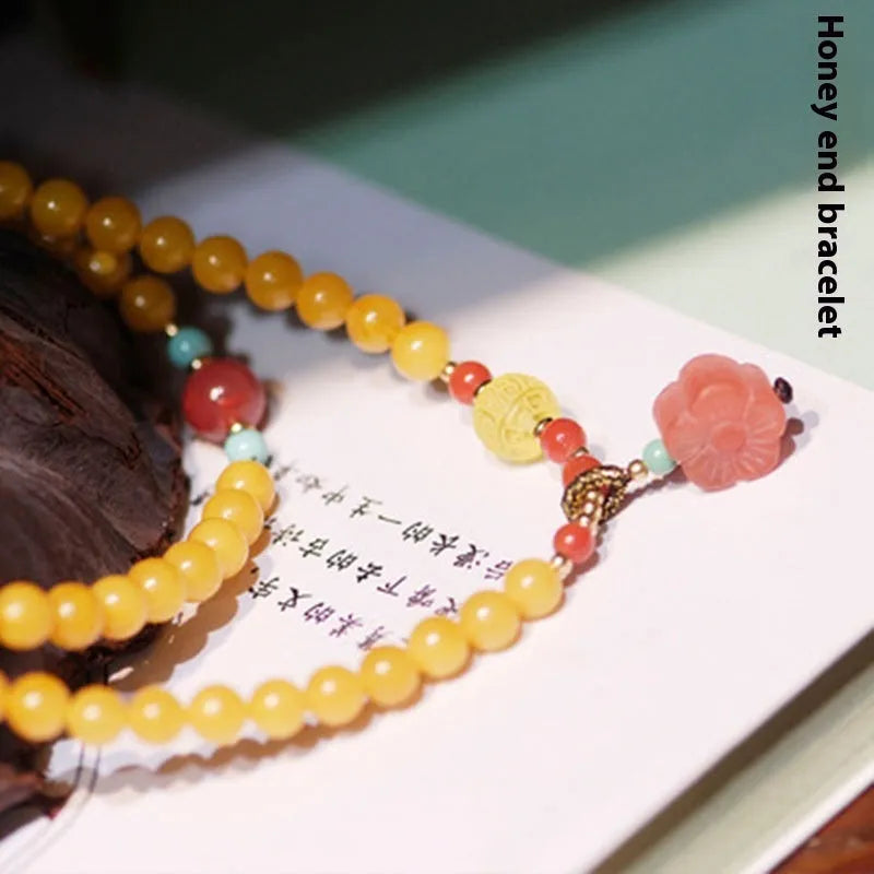 Yellow amber bracelet with 5mm round beads and animal zodiac design on wrist