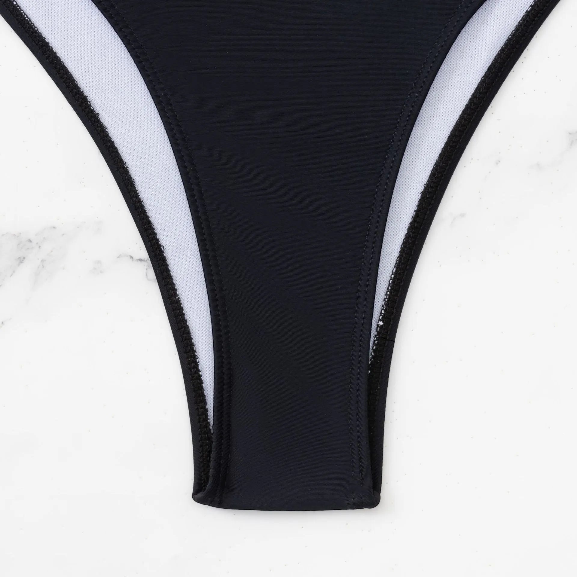 Black women's one-piece swimsuit with white stitching and hollow cut-out design