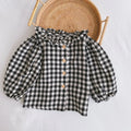 Baby girl wearing a pleated lotus leaf design cotton romper in a triangle climb style.