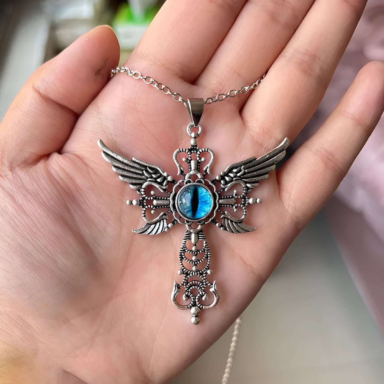 Geometric devil wings and cross pendant necklace in alloy, shown in a choice of blue, green, purple, red, or yellow colour finishes.