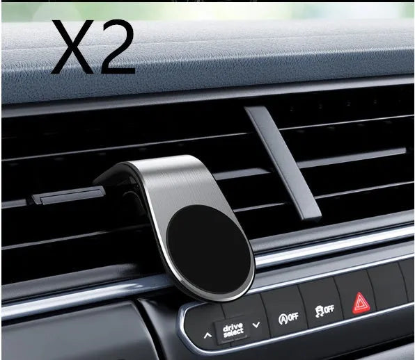 Black universal car phone holder bracket mounted on a car dashboard holding a smartphone.