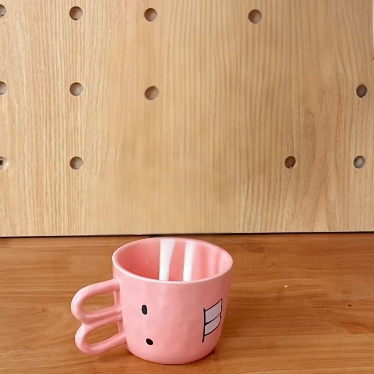 Creative ceramic piggy teapot nose mug set with pink pig pot and rabbit cup on a table