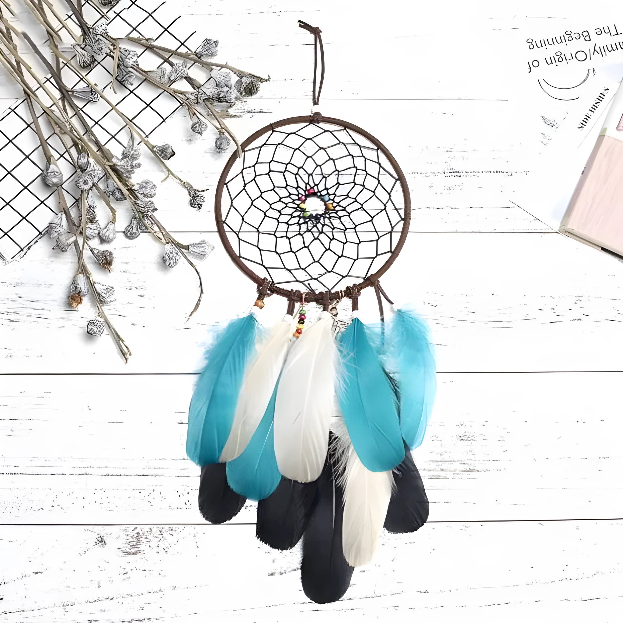 Ancient Dream dreamcatcher feather wind chime hanging ornament measuring 16x50cm on a wall