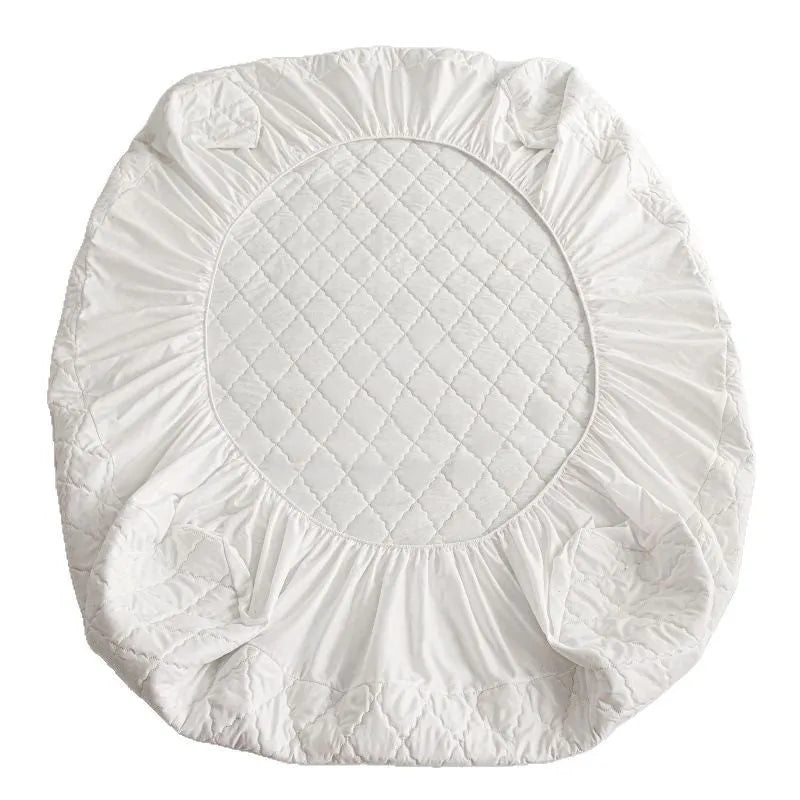 Diamond quilted black waterproof mattress protector fitted sheet and pillowcases set on a bed