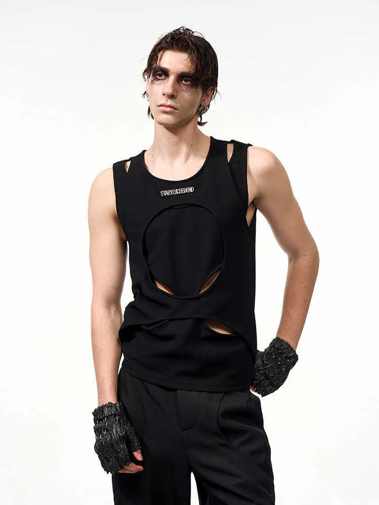 Man wearing a white, sleeveless, hollow-knit cotton waistcoat with a round neck.
