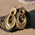 Close-up of French retro double circle copper earrings with a quicksand finish in a U-shape.