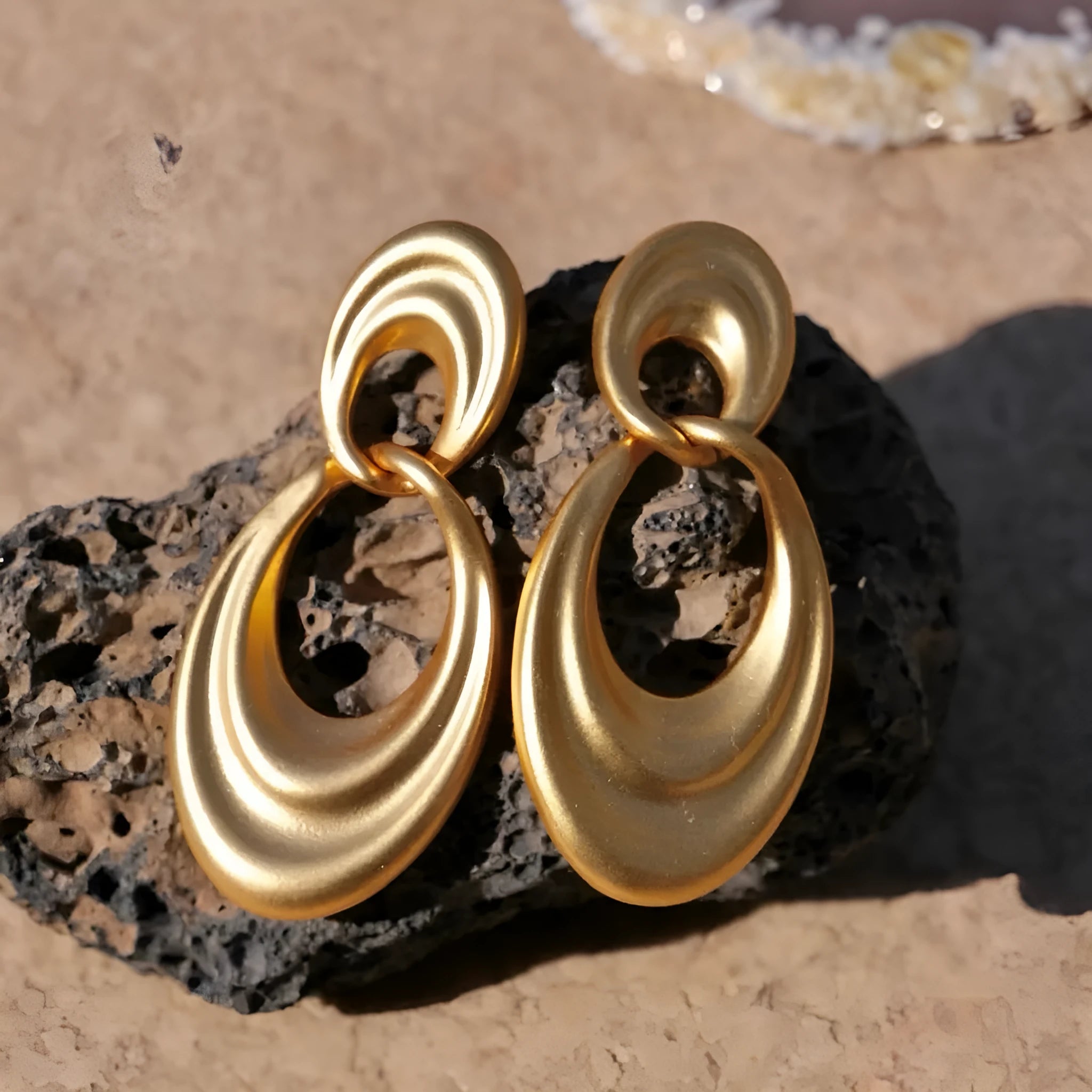 Close-up of French retro double circle copper earrings with a quicksand finish in a U-shape.