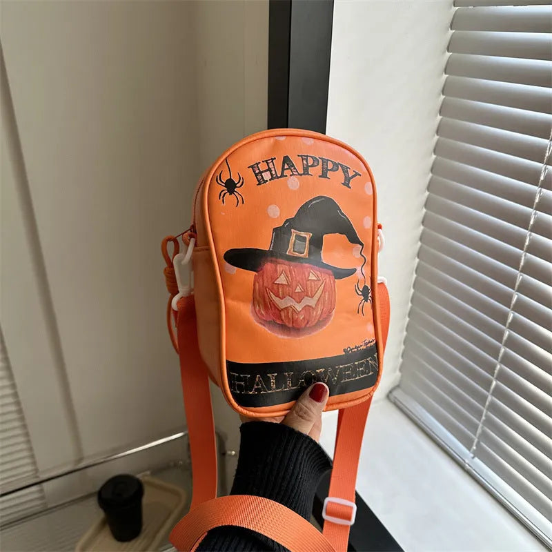 Black Halloween crossbody bag with orange pumpkin, white ghost, and bat graffiti print, shown on a model.