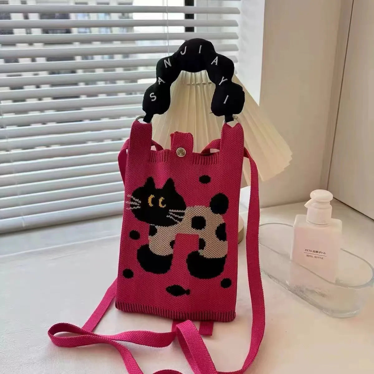 Cartoon knitted messenger bag with woven design and single shoulder strap