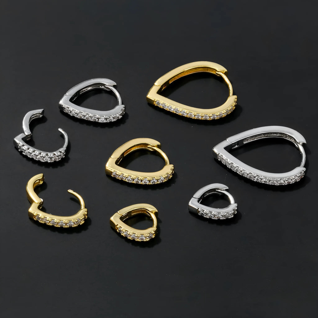 A geometric heart-shaped gold ear clip for women on a white background.