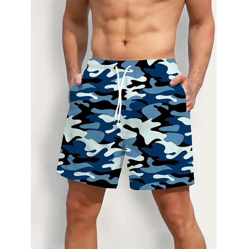Men's printed polyester beach shorts on a model, showing elastic waistband and casual fit.
